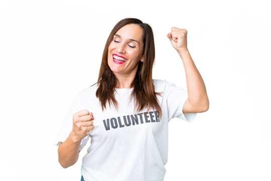 Middle age volunteer woman over isolated chroma key background celebrating a victory