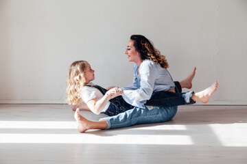 mother and daughter together play motherhood on a white background