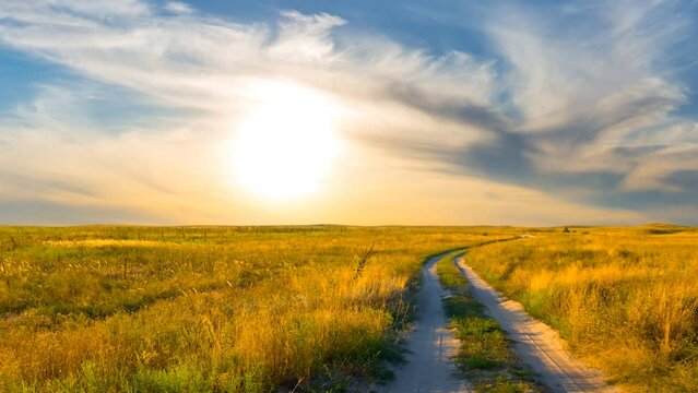  summer prairie with ground road at the evening time lapse scene
