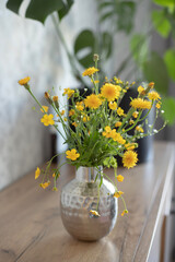Fresh yellow wildflowers in home interior