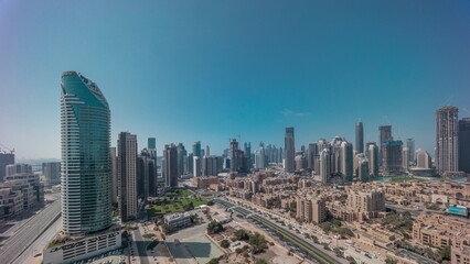 Naklejka na ściany i meble Dubai's business bay towers aerial morning timelapse. Rooftop view of some skyscrapers