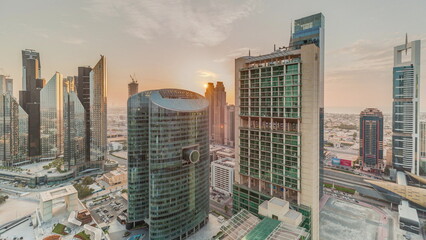Sunset over Dubai international financial center skyscrapers aerial timelapse.