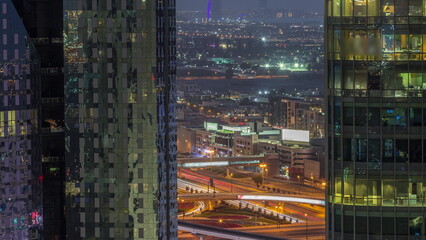 Villas and famous hotel in the horizon line from Dubai downtown with big intersection aerial day to night timelapse