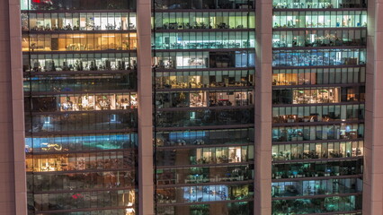 Big glowing windows in modern office and residential buildings day to night timelapse