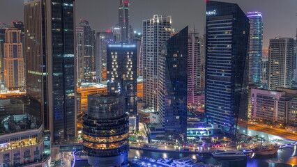 Obraz premium Dubai Marina Skyline with JLT district skyscrapers on a background aerial all night timelapse.