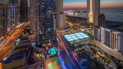 Panoramic view of the Dubai Marina and JBR area and the famous Ferris Wheel aerial day to night...