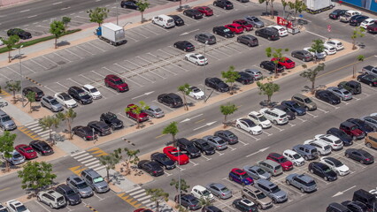 Top view busy parking lot with many cars moving in and out timelapse.
