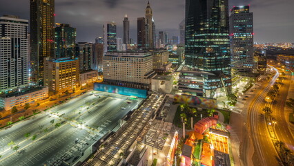 Dubai International Financial district aerial all night timelapse. Panoramic view of business and financial office towers.