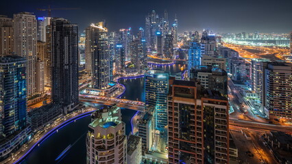 Obraz premium Panorama showing various skyscrapers in tallest recidential block in Dubai Marina aerial night timelapse