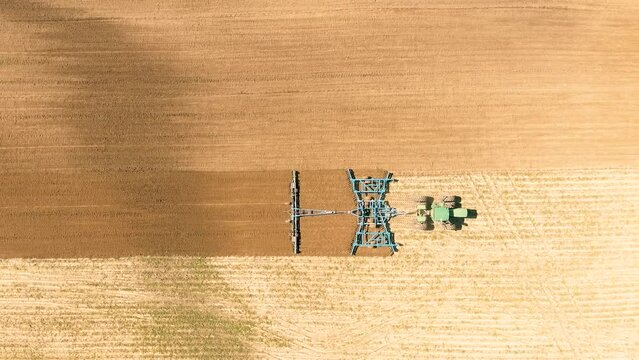 Drone Video of Tractor Plowing Field Top Down