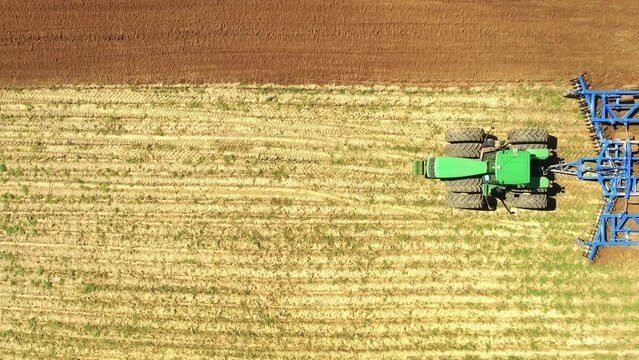 Drone Video of Tractor Plowing Field Top Down 3