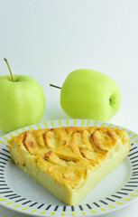 Homemade, apple pie, in porcelain dish and light background, vertical shot and copy space.