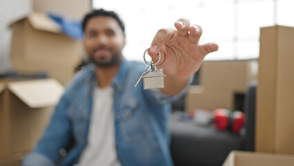 African american man smiling confident holding new house keys at new home