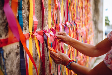 Fototapeta na wymiar A person is tying ribbons on a wall. Generative AI