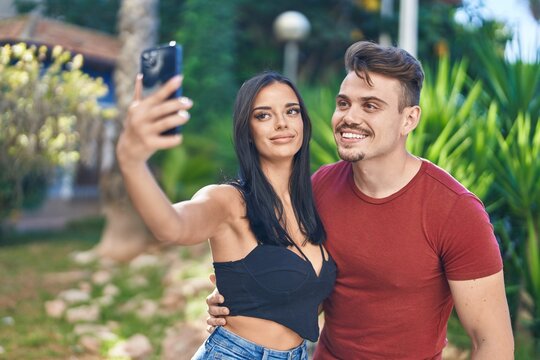 Man and woman couple smiling confident make selfie by smartphone at park