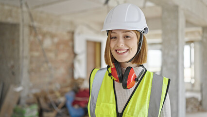 Young blonde woman architect smiling confident standing at construction site