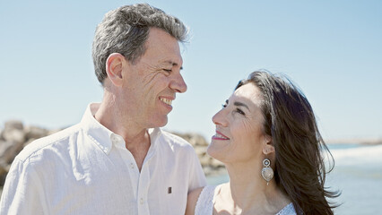 Fototapeta premium Senior man and woman couple smiling confident standing together at seaside