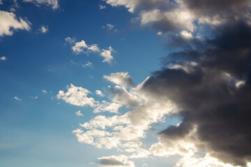 Fototapeta premium Black cloud and blue sky in sunlight