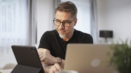 Man working with laptop in home office