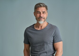 Portrait of happy casual older bearded man with gray hair smiling, Mid adult, mature age guy standing, isolated on gray background. - 611441916