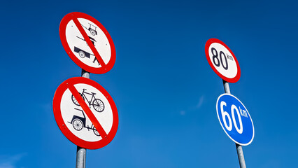 Low Angle View of Road Signs of Prohibition and Speed-Limit for Safety Driving. Safely-Driving Knowledge Concept. 