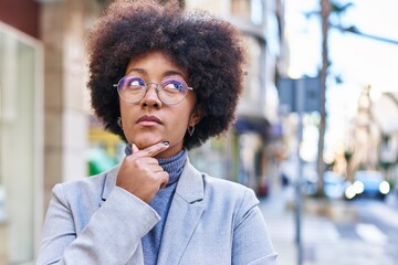 African american woman executive standing with doubt expression at street