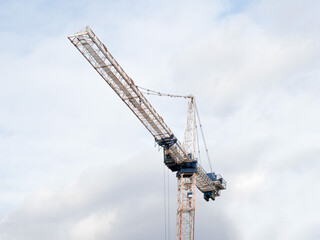 a construction tower crane on a high rise building project