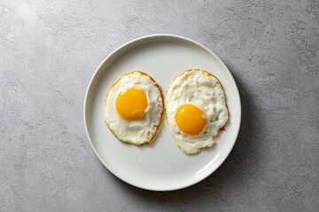 Fried eggs in a plate, food breakfast, healthy proteins.
