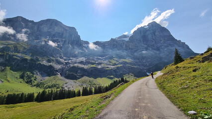 Small cycling road in a mountain landscape with dramatic clouds