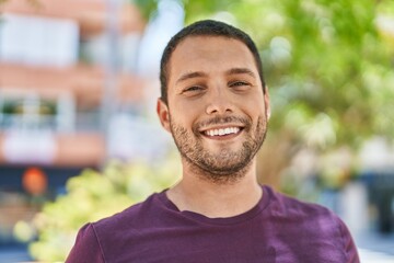 Young man smiling confident standing at park