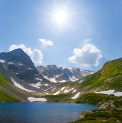 small lake in green mountain valley at the sunny day