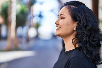 Young chinese woman smiling confident standing at street