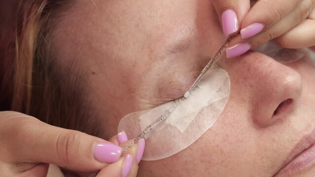 Cosmetic eyelash extension procedure in a beauty salon