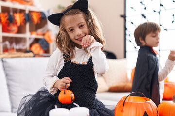 Fototapeta premium Adorable boy and girl having halloween party smiling confident at home