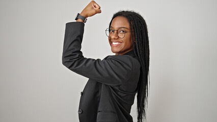 African american woman business worker doing strong gesture with arm smiling over isolated white...