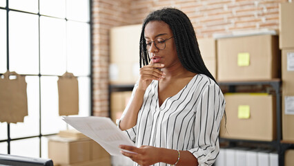 African american woman ecommerce business worker reading document at office