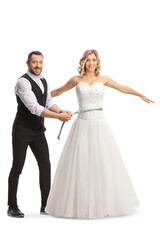 Fototapeta na wymiar Man measuring waist of a bride in a gown