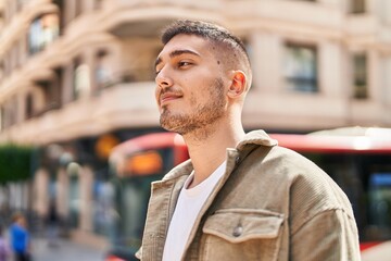 Young hispanic man smiling confident standing at street