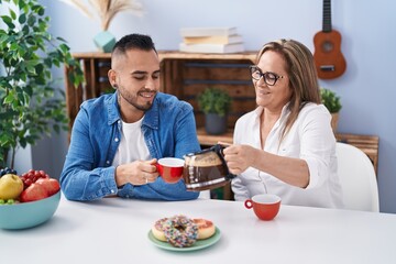 Man and woman mother and son drinking coffee at home