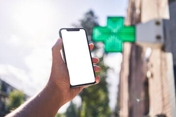 Man holding smartphone showing white blank screen at pharmacy