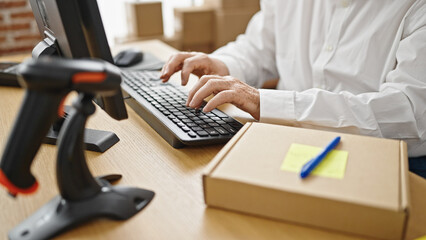 Middle age grey-haired man ecommerce business worker using computer at office