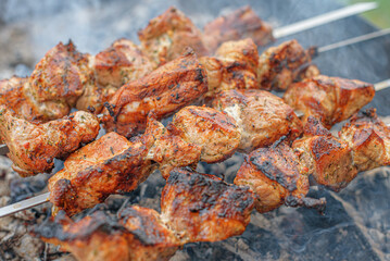 Pork skewers are cooked on the grill.