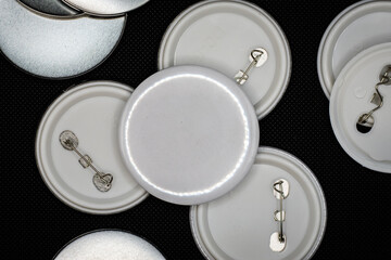 Blank plastic pin or button badge on a plain black background. Mockup image.