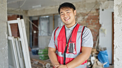  builder smiling confident standing at construction site