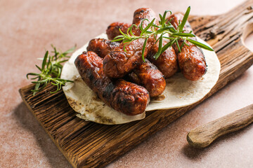 Grilled meat sausages. Fried sausage. Fried anchovies preparing for consumption. Copy space for text