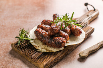 Grilled meat sausages. Fried sausage. Fried anchovies preparing for consumption. Copy space for text