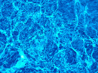 Abstract design of turquoise swimming pool water with sunshine reflection