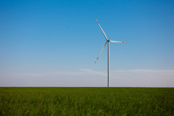 Panoramic view of wind farm or wind park, with high wind turbines for generation electricity with copy space. Green energy concept, in the world.