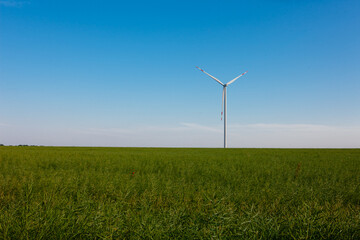 Panoramic view of wind farm or wind park, with high wind turbines for generation electricity with copy space. Green energy concept, in the world.