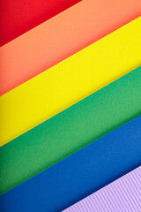 Rainbow flag from stripes of multicolored paper, close up. LGBT Pride month concept
